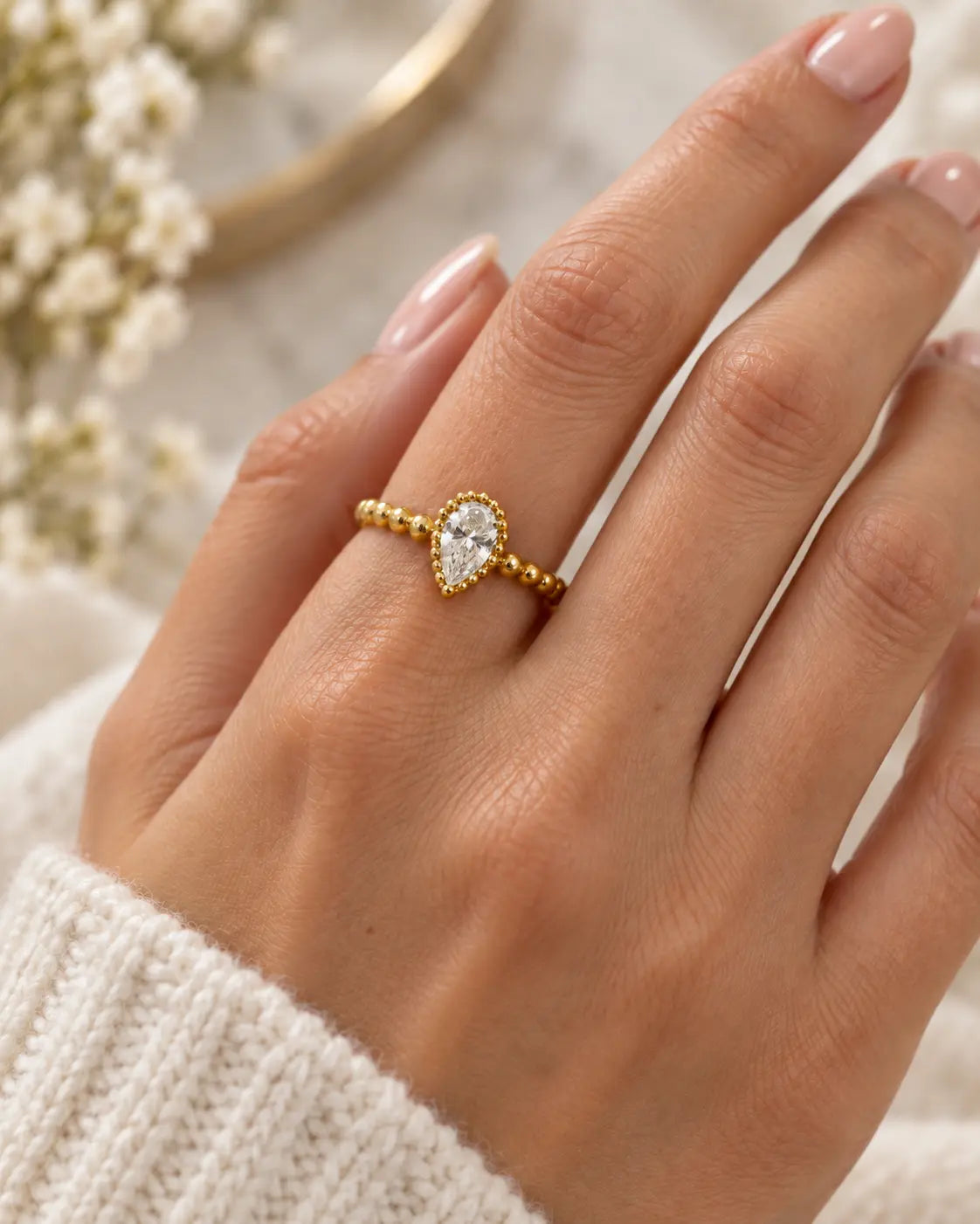 10K yellow gold pear-shaped beaded ring worn on hand