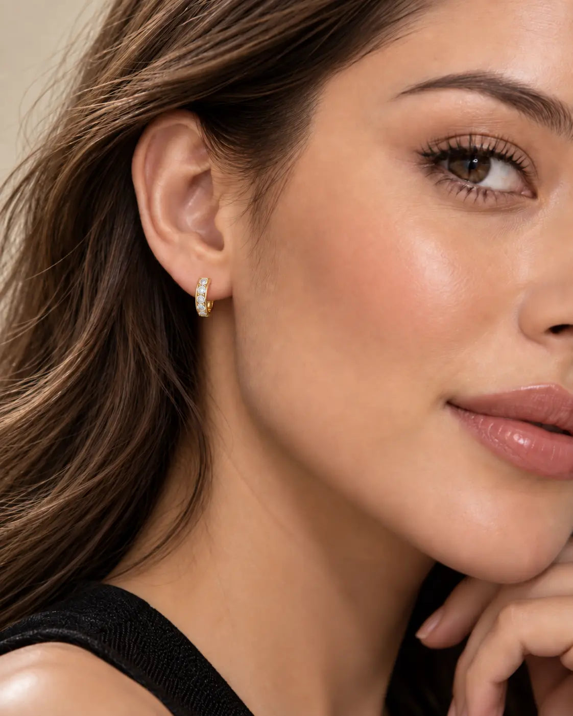 Model wearing 10K gold 11.5mm clear zircon huggie hoop earring