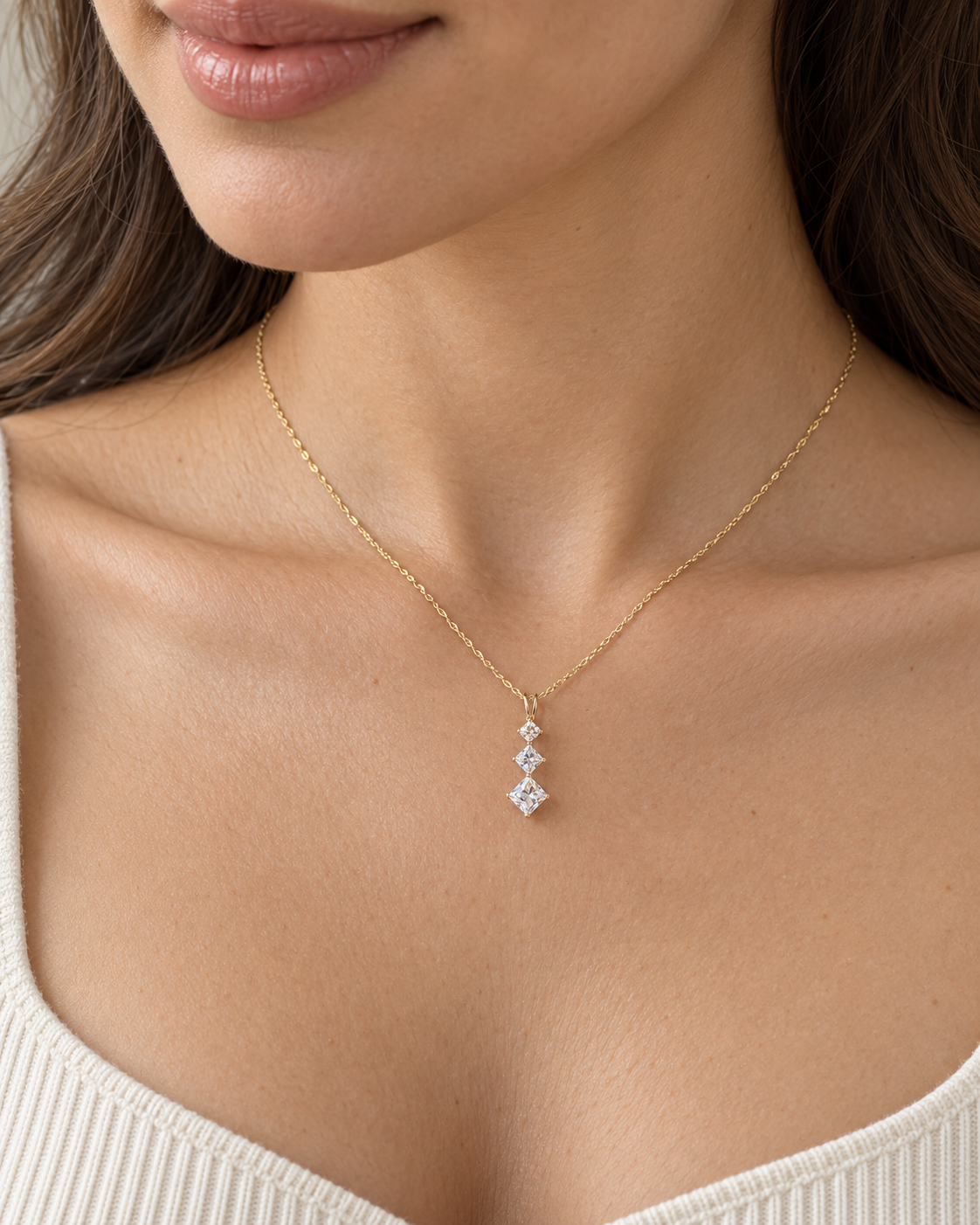 Model wearing 15-inch 14K yellow gold fine twisted chain three-stone necklace