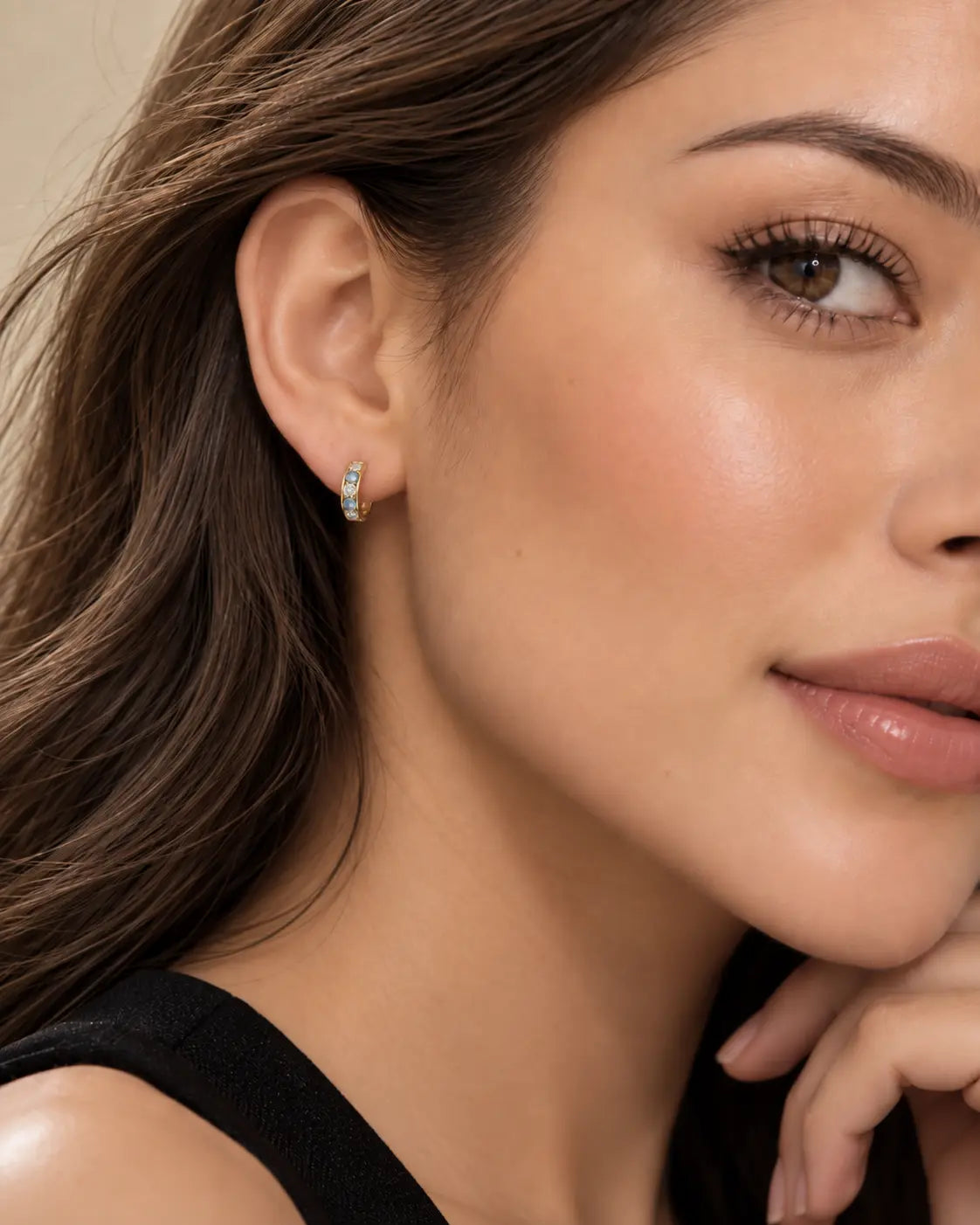 Model wearing 10K gold 11.5mm sky blue and zircon huggie hoop earring